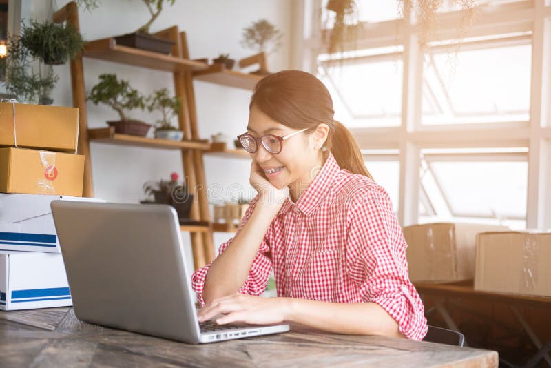 Young start up small business owner working computer workplace freelance woman entrepreneur sme seller check product order